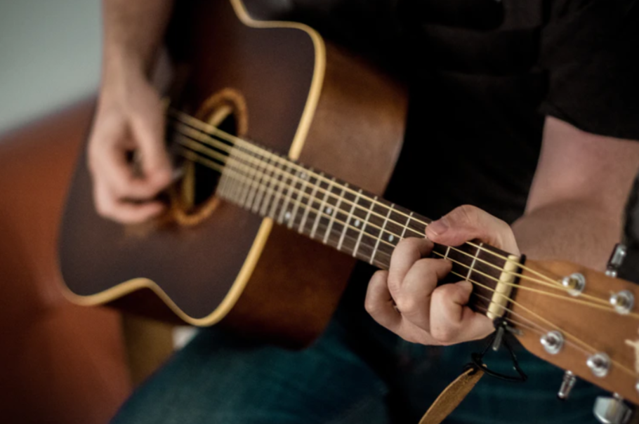 person playing guitar photo